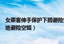 女乘客伸手保护下蹲避险空姐（遇强气流女乘客伸手护着蹲地避险空姐）